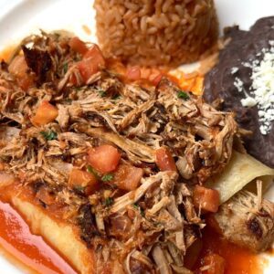 Red Enchiladas Rancheras (Carnitas / Mexican Pulled Pork) - Carnitas are on top and filled with cheese.